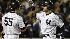 New York Yankees Derek Jeter, right, is...