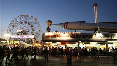 In this file photo from Sept. 7, 2008, the entrance to Astroland Park is seen from the boardwalk at night in the Coney Island neighborhood of New York. A private arts group and New York City Hall are engaged in separate efforts to rejuvenate Coney Island that could lead to the reincarnation of the historic ocean side amusement complex with new year-round entertainment facilities, officials said on Monday, Nov. 17, 2008.