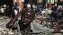 A boy, bleeding from the head, grimaces after he...