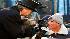 Punxsutawney Phil, center, is held by John...