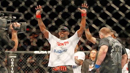 Jon Jones, center, celebrates after beating Vladimir Matyushenko, right, during their UFC on Versus mixed martial arts match at the San Diego Sports Arena in San Diego on Sunday, Aug. 1, 2010.