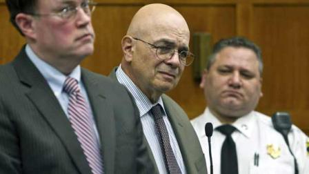 Robert Oliva, center, former basketball coach at Christ the King Regional High School in New York, stands with his attorney Michael Doolin, left, Monday, April 4, 2011, in Suffolk Superior Court in Boston. Oliva was sentenced Monday to five years probation after pleading guilty to two counts of child rape and one count of disseminating pornography to a minor. Oliva is accused of abusing a 14-years-old during a 1976 trip to a Red Sox-Yankees game.