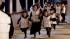 Women and children run for the lifeboats as the...