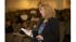A community member voices her opinion to the...