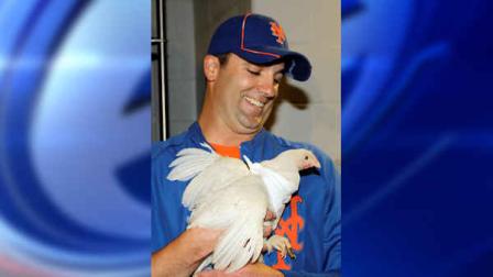 New York Mets relief pitcher Tim Byrdak holds Little Jerry Seinfeld, the chicken that he brought into the clubhouse before handing it off to representatives of the Farm Sanctuary of Watkins Glen, N.Y., before the Mets faced the New York Yankees in their interleague baseball game at Citi Field in New York, Sunday, June 24, 2012. (AP Photo/Kathy Willens)