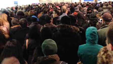 Crowds gathered at the World Trade Center PATH station Friday after ice falling off 1 World Trade prompted a service suspension.