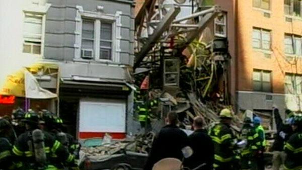 Officials said a crane has collapsed away from a building under construction onto an occupied building.