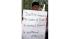 An Afghan protestor holds a poster at a...