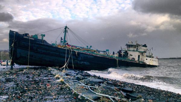 A 168-foot water tanker, the John B. Caddell, sits on the shore Tuesday morning, Oct. 30, 2012 where it ran aground on Front Street in the Stapleton neighborhood of New York's Staten Island as a result of superstorm Sandy.
