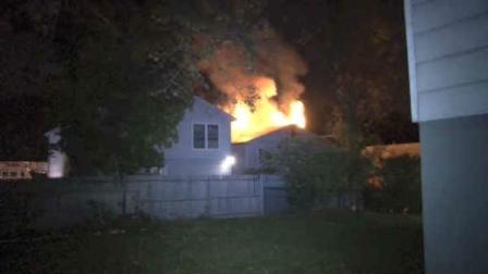 Flames shot through the roof of the house on Sears Avenue Saturday night.
