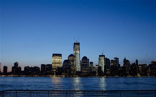 One World Trade Center towers above the Lower Manhattan skyline and Hudson River, Monday, March 26, 2012, in New York. The tower, now up to 93 floors, will reach 104 floors and is scheduled for completion in 2013. (AP Photo/Mark Lennihan)