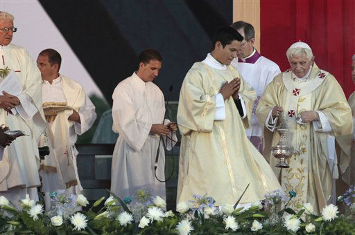 Pope Benedict XVI waves after a prayer the...