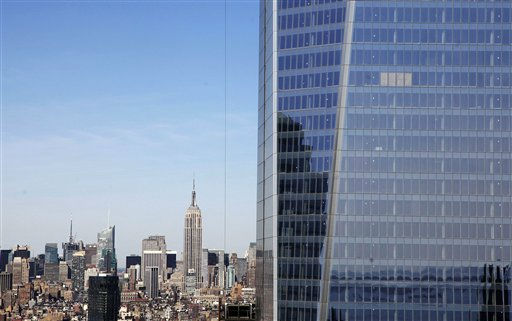 In this April 17, 2012, file photo, One World Trade Center, right, rises above the Manhattan skyline and the Empire State Building, center, in New York. One World Trade Center, the giant monolith being built to replace the twin towers destroyed in the Sept. 11 attacks, will lay claim to the title of New York City?s tallest skyscraper on Monday, April 30 as workers erect steel columns that will make its unfinished skeleton a little over 1,250 feet, just high enough to peak over the observation deck on the Empire State Building, center. The milestone is a preliminary one. The so-called ?Freedom Tower? isn?t expected to reach its full height for at least another year, at which point it is likely to be declared the tallest building in the U.S. (AP Photo/Mark Lennihan, File)