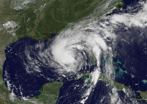 In a satellite image provided by the National Oceanic and Stmospheric Administration and Made at 1145 a.m. EDT Monday Aug. 27, 2012, tropical storm Isaac can be seen as it moved towards New Orleans. As Isaac approaches Louisiana on Tuesday, residents along the state's vulnerable, low-lying coast boarded up homes and fled for shelter while storm-wary residents of New Orleans were reassured that levees fortified after Katrina could withstand the anticipated hurricane. (AP Photo/NOAA)