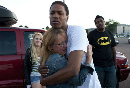 Emma Goos, 19, hugs her mother, Judy Goos,...