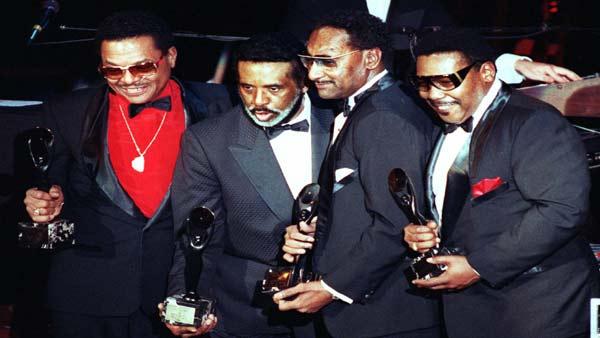 Clineice Stubbs, wife of Four Tops member, Levi Stubbs; Four Tops member Abdul Fakir; Levi Stubbs; Yone Payton, wife of deceased member Lawrence Payton and Four Tops member, Renaldo Benson; from left, display the Michigan Senate Resolution that declared Wednesday, May 26, 2004, Four Tops Day in the State of Michigan, in the Senate Chambers of the State Capitol in Lansing, Mich. (AP Photo/Kevin W. Fowler)