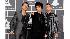 Greenday band members, from left, Mike Dirnt, Billie Joe Armstrong and Tre Cool arrive at the Grammy Awards on Sunday, Jan. 31, 2010, in Los Angeles. 