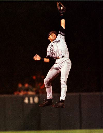 New York Yankees Derek Jeter follows through on...
