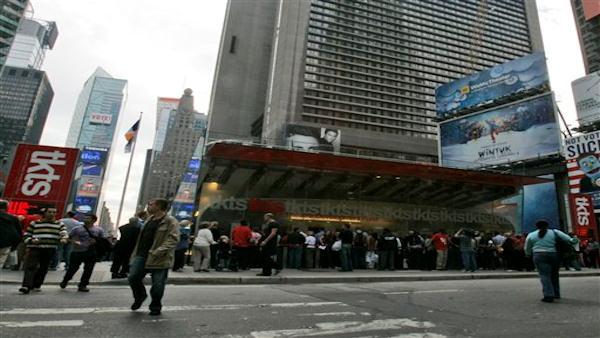 Customers line up at the TKTS booth to buy discounted theater tickets.
