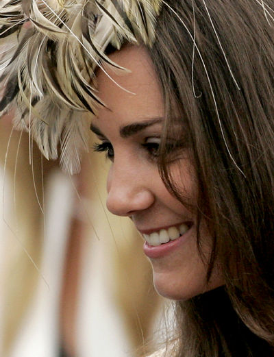 Prince William holds her hand as Kate Middleton...