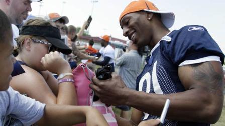 Chicago Bears wide receiver Sam Hurd, right, smiles as he autographs for fans before NFL football training camp Sunday, July 31, 2011, at Olivet Nazarene University in Bourbonnais, Ill. (AP Photo/Nam Y. Huh)