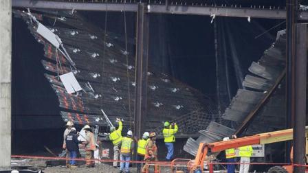 Workers and officials inspect the scene of a collapse at the Horseshoe Casino under construction, Friday, Jan. 27, 2012, in Cincinnati.