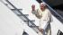 Pope Benedict XVI waves as he boards a plane on...