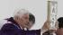 Pope Benedict XVI holds up the book of the...