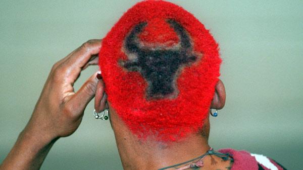 Dennis Rodman, sporting red hair with a Bulls insignia in the back, speaks during a news conference during media day at the Chicago Bulls training center in Deerfield, Ill, Thursday Oct. 5, 1995.  (AP Photo/Beth A. Keiser)