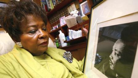 Addie Wyatt looks at a framed photo of her friend, slain civil rights leader the Rev. Martin Luther King Jr. at her Chicago home on Thursday, Jan. 13, 2005. (AP Photo/Nam Y. Huh)