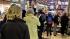 Hopefuls lineup at a newstand to buy lottery...