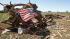 A flag lays on the twisted metal base of a...