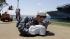 A worker approaches the legs of the statue...