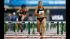Lolo Jones clears a hurdle in front of Kori...