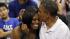 President Barack Obama kisses the head of first...