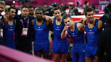 U.S. gymnasts Danell Leyva, left, John Orozco, forth left, Samuel Mikulak, right, Jonathan Horton, second right, and Jacob Dalton, center, pose for a team photograph along with coaches Kevin Mazeika, left, and Tom Meadows during the Artistic Gymnastics mens qualification at the 2012 Summer Olympics, Saturday, July 28, 2012, in London. (AP Photo/Matt Dunham)