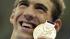 United States' Michael Phelps poses with his gold medal for the men's 4x200-meter freestyle relay swimming final at the Aquatics Centre in the Olympic Park during the 2012 Summer Olympics in London, Tuesday, July 31, 2012. The medal was Phelps' 19th, pushing the swimmer past Larisa Latynina, who won 18 medals in the 1956, 1960 and 1964 Olympics while competing for the Soviet Union. (AP Photo/Matt Slocum)