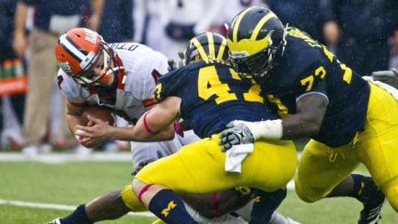 Illinois quarterback Reilly OToole (4) is tackled by Michigan linebacker Jake Ryan (47) and defensive tackle William Campbell, right, during the second quarter of an NCAA college football game, Saturday, Oct. 13, 2012, in Ann Arbor, Mich. (AP Photo/Tony Ding)