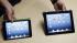The iPad Mini, at left, is shown next to the 4th...