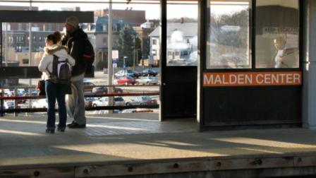 FILE: People wait on the platform of the MBTA station in Malden, Mass.