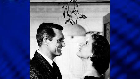 Actor Cary Grant holds actress Ingrid Bergman under the mistletoe, on December 1957 during shooting of a Christmas scene movie in Indiscreet. (AP Photo/Warner Bros)