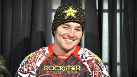 In this photo released by ESPN Images, snomobiler Caleb Moore smiles while attending a news conference at the Winter X Games in Aspen, Colo.
