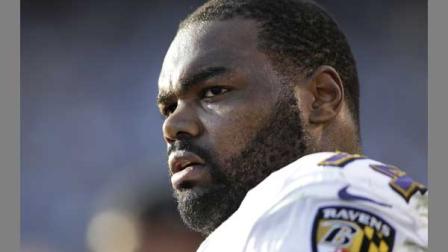 In this Nov. 25, 2012 file photo, Baltimore Ravens tackle Michael Oher sits on the sidelines during the second half of an NFL football game against the San Diego Chargers, in San Diego. Oher and his adoptive family were depicted in the book and movie, The Blind Side.