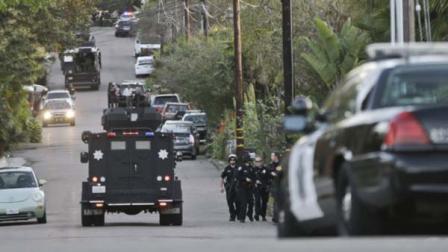 A third armored vehicle arrives in support of police and sheriffs officers outside a home in Encinitas, Calif.