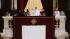 Pope Francis stands at the central balcony of...