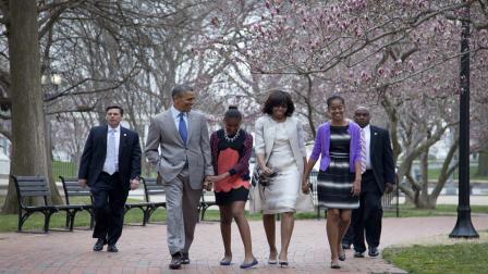 President Barack Obama and first lady Michelle Obama walk from the White House with their daughters Sasha Obama, second from left, and Malia Obama, right.