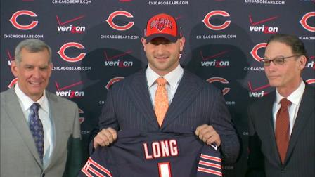 Bears draft pick Kyle Long (center) stands alongside general manager Phil Emery (left) and head coach Marc Trestman (right), Friday, April 26, 2013.