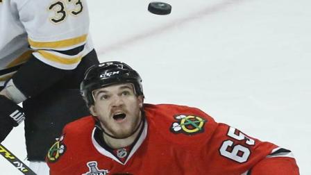 Chicago Blackhawks center Andrew Shaw (65) keeps the puck in sight on a rebound during Game 2 of the NHL hockey Stanley Cup Finals against the Boston Bruins, Saturday, June 15, 2013, in Chicago. (AP Photo/Charles Rex Arbogast)