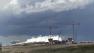 Storm clouds are seen over Denver International Airport on Tuesday, June 18, 2013, where a tornado touched down and forced passengers and employees into shelters. No one was injured and there was no apparent damage. (AP Photo/Ed Andrieski)