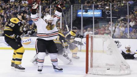 Chicago Blackhawks left wing Brandon Saad, center, celebrates a goal by Chicago Blackhawks center Michal Handzus, right, of Slovakia, in front of Boston Bruins defenseman Zdeno Chara (33), of Slovakia, during the first period in Game 4 of the NHL hockey Stanley Cup Finals, Wednesday, June 19, 2013, in Boston. (AP Photo/Elise Amendola)